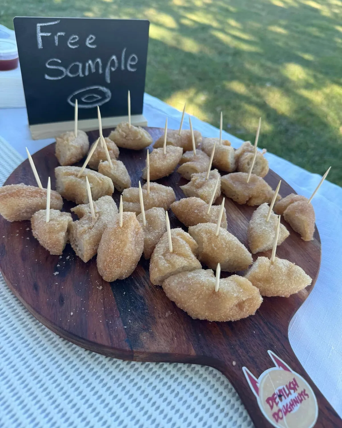 Free sample doughnut pieces on a wooden board