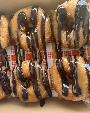 A box of chocolate drizzled doughnuts