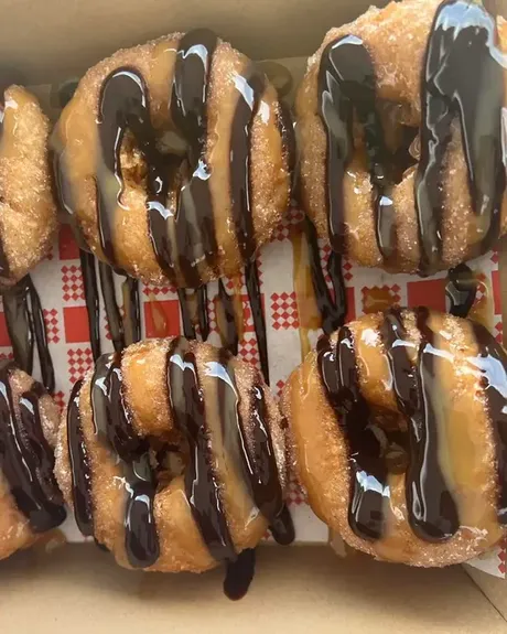 A box of chocolate drizzled doughnuts
